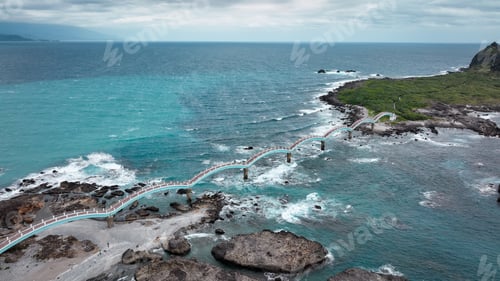 Preview: Scenic view of Sanxiantai bridge connecting to lush coastline in Taiwan during overcast day