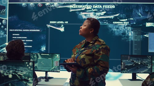 Preview: Woman high tech specialist studying satellite CCTV visualization on a big screen
