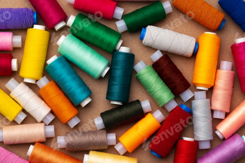 Preview: Many colored spools of threads as a background