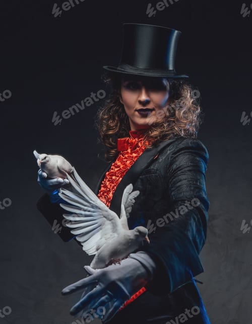 Preview: Female artist with curly hairs showing a magic trick with doves