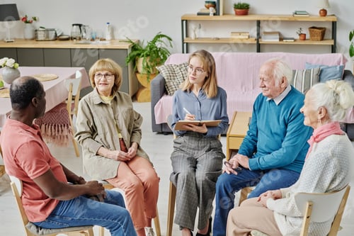 Preview: Senior people talking to psychotherapist at session