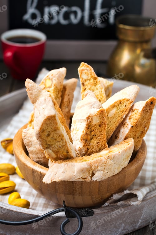 Preview: Homemade biscotti with nuts and a cup of coffee on the old wooden table background. Selective focus