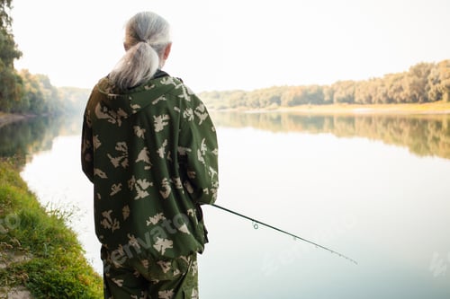 Preview: senior concept. pensioner fishes on the river in his spare time. A useful hobby, outdoor activities