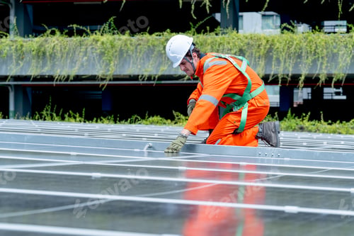 Preview: Professional technician worker or engineer sit on solar cell panel and check or maintenance