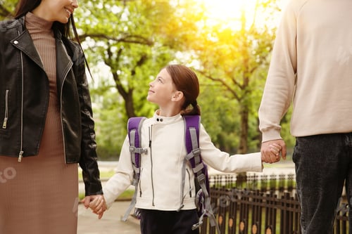 Preview: Parents taking their little daughter to school outdoors