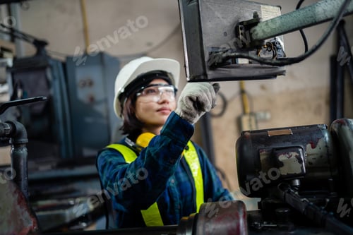 Preview: Close-up worker in safety suit using tablet at industrial plant. Metal fabrication industry