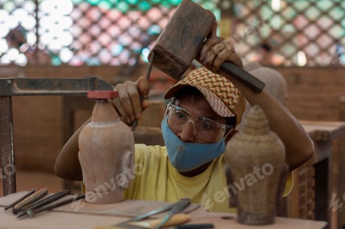 Preview: Craftsman intently shaping pottery with tools in a workshop