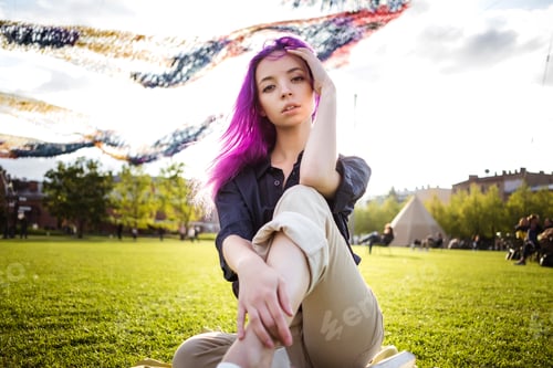 Preview: Beautiful young violet hairy girl walking at sunset in a city park. St. Petersburg, New Holland