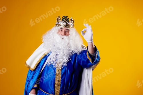 Preview: The Magician King making the Ok gesture on a yellow background