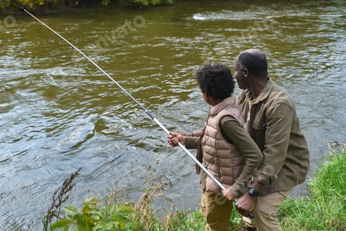 Preview: Father Supporting Son while He Fishing