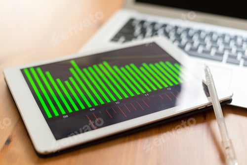 Financial Chart on Tablet with Laptop Computer