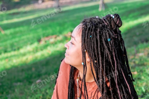 Preview: Portrait of beautiful European woman with long African braids. Woman is doing yoga exercise.