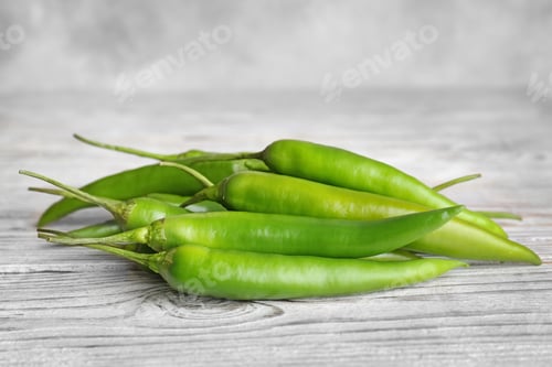 Preview: Pile of ripe chili peppers on wooden table