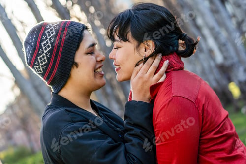 Preview: Lesbian couple smiling and leaning in for a kiss