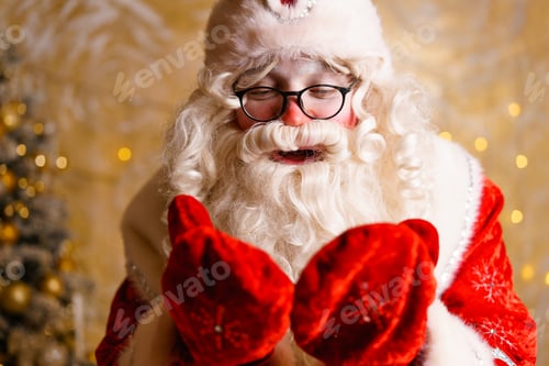 Preview: Cute santa claus in glasses on a wall background with a bright garland bokeh