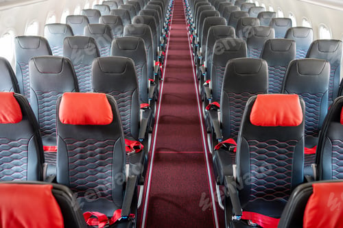 Preview: Empty interior of cabin of airplane with rows of black and red seats, High angle view