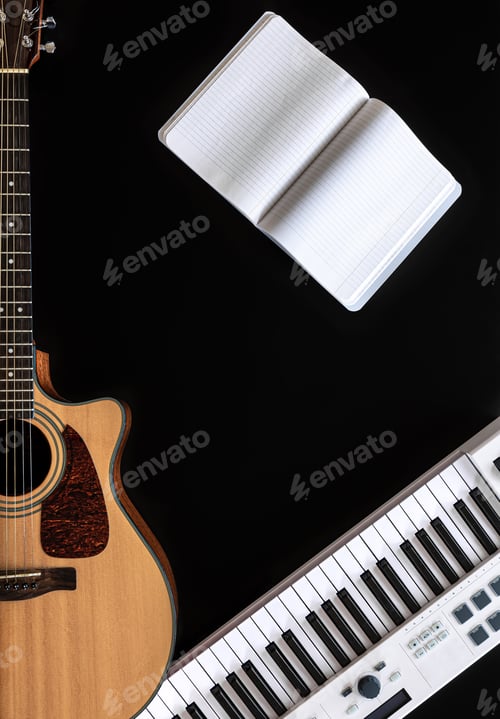 Preview: Music background with acoustic guitar, notepad and music keys on black.