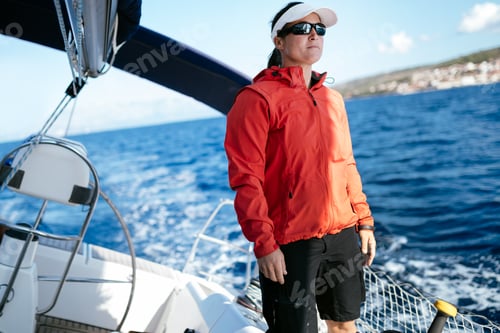 Preview: Attractive strong woman sailing with her boat