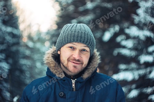 Preview: *** Nominated *** Portrait of smiling bearded man traveler forester hunter in the winter forest