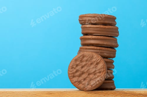 Preview: Stack of glazed chocolate cookies on blue background