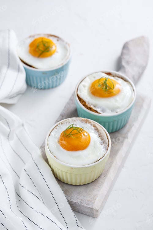 Preview: Shirred baked eggs for breakfast. Selective focus copy space