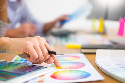 Preview: designer Editor at work drawing sketches a new project on graphic tablet and color palette sitting
