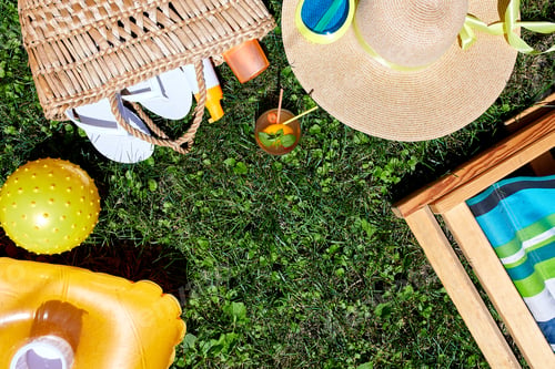 Preview: Flat lay of outdoor bright summer beach vacation or travel lifestyle concept on grass background