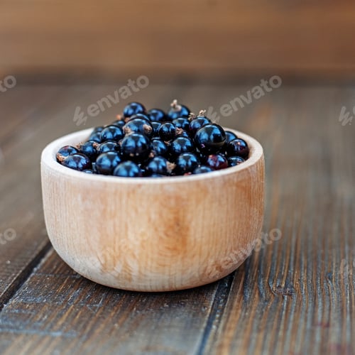 Preview: Useful berry. Black currants in a wooden bowl. Square. The conce