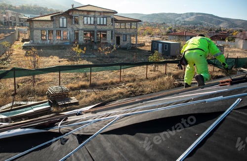 Preview: Worker on Rooftop Installing New Tiles