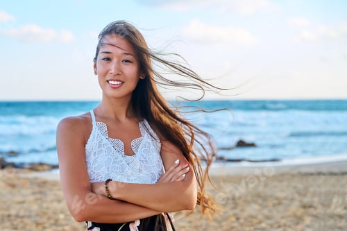 Preview: Outdoor portrait of happy beautiful young woman, on sea beach, copy space