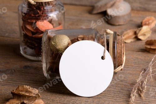 Preview: Round white tag mockup on glass jar with dry perfume a wooden background with boho decoration