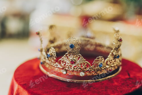 Preview: Christian golden crown for holy matrimony on red table in church