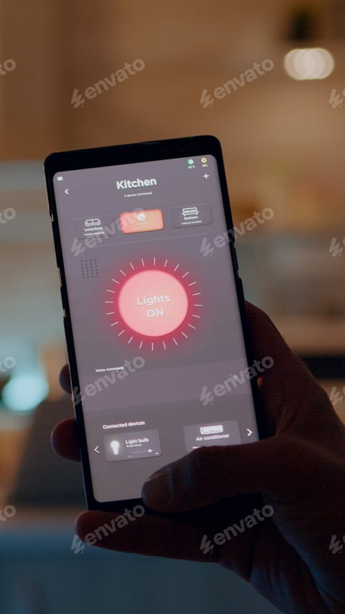 Preview: Man holding smartphone with lighting control application, turning on bulbs