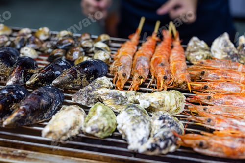 Preview: Mixed seafood barbecue on grill metal net