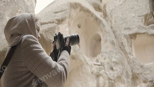 Preview: Beautiful woman takes pictures on trip with professional camera. Action. Female photographer takes