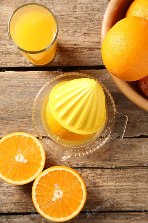 Preview: Tasty orange juice, fresh fruits and juicer on wooden table, flat lay