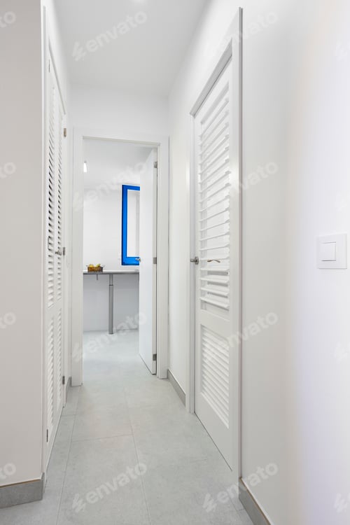Preview: Home corridor in white color with wooden slatter doors. Vertical