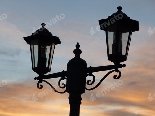 Preview: a street light with a colorful sky behind it, silhouetted at sunset