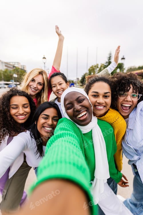 Preview: Happy young group of diverse women taking selfie portrait at city street
