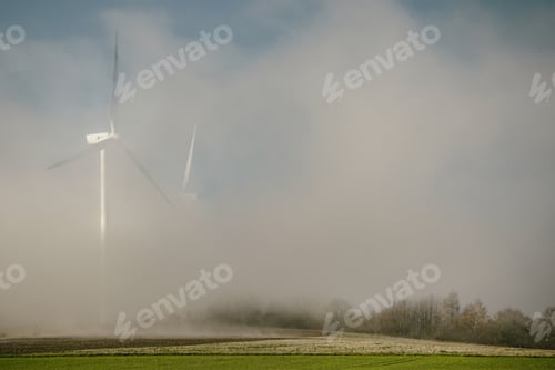 Preview: Large field with wind turbines on a foggy day