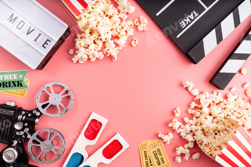 Preview: Top view of movie tools, popcorn, 3-D glasses, Cinema tickets, clapper board and light box on pink