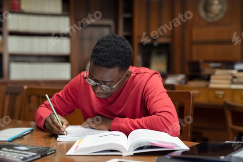 Preview: Student in library studying for exam