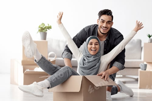 Preview: Positive muslim family playing with packing supplies while moving