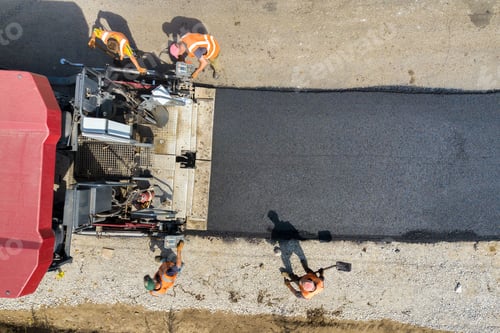 Preview: Aerial view of new road construction with asphalt laying machinery at work.