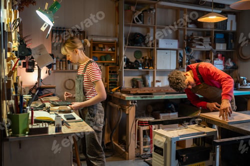 Preview: Family carpentry workshop. Busy spouses of carpenters working on wood in joinery.