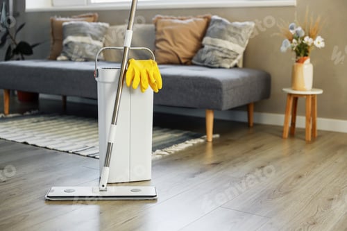 Preview: Cleaning supplies: mop, gloves, bucket with wringer on wooden laminate floor