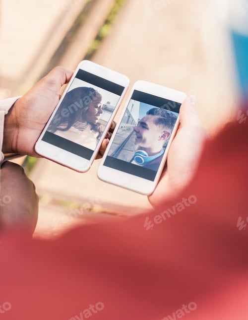 Preview: Hands holding smart phones with pictures of a young couple