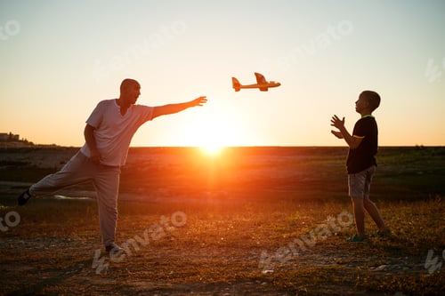 Preview: Soft focus of father and son playing toy airplane