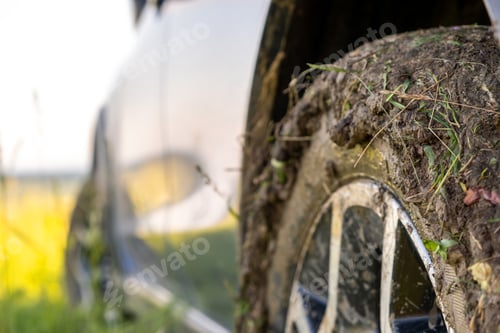 Preview: Close up of dirty off road car wheels with dirty tires covered with yellow mud