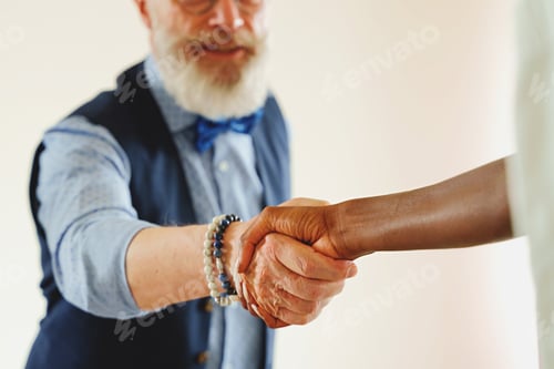 Preview: Stylish Man and African Woman Handshake
